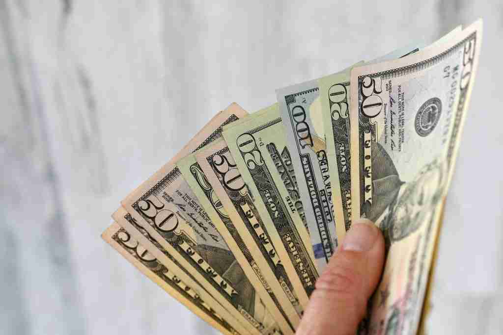 a female holds a handful of money currency cash 2022 11 14 03 47 48 utc