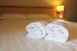 bedside lamp pillows and hotel room bed with fres 2022 11 15 16 42 18 utc