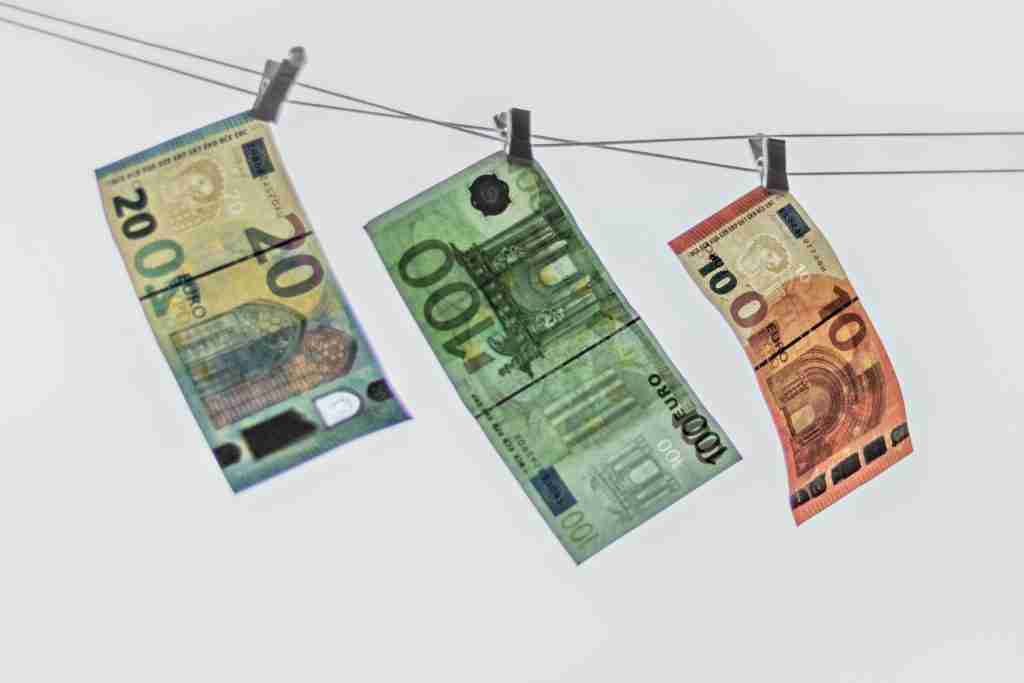 euro banknotes hang on a clothesline on a white ba 2022 11 12 07 55 01 utc