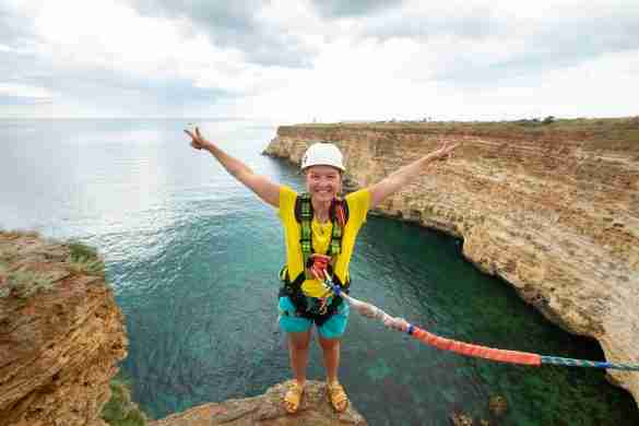 young woman jump from the cliff with a rope ropej 2022 09 06 04 26 16 utc